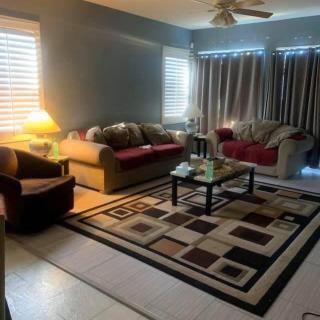 A cozy living room with sofas, a coffee table, and a patterned rug.