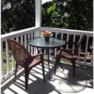 Cozy patio with a table and chairs set in sunlight.