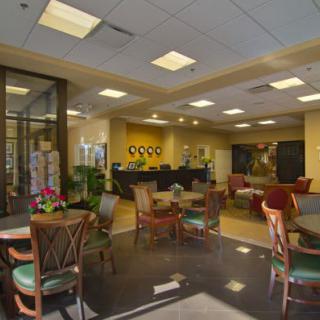 A well-lit lobby with seating arrangements and a reception desk.