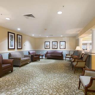 A spacious and well-lit lobby with comfortable seating and decorative artwork.