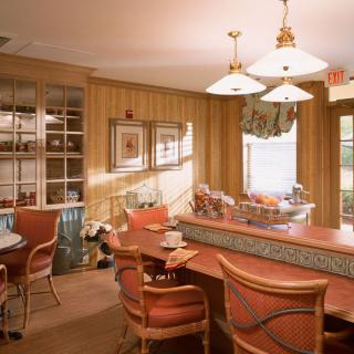 A cozy living room with a bar area, featuring comfortable seating and warm lighting.