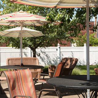 A peaceful outdoor patio setup with tables and umbrellas, perfect for relaxation.