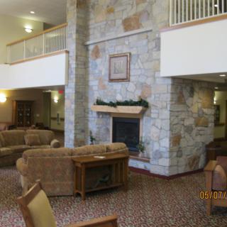 A spacious lobby with comfortable seating and a stone fireplace.