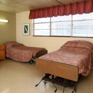 A shared room with two hospital beds in a healthcare facility.