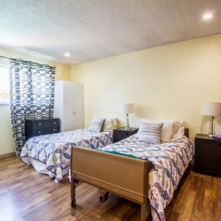 A cozy bedroom with twin beds and modern decor.