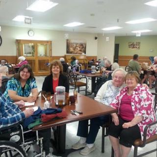 A lively gathering of seniors enjoying each other's company at a community center.