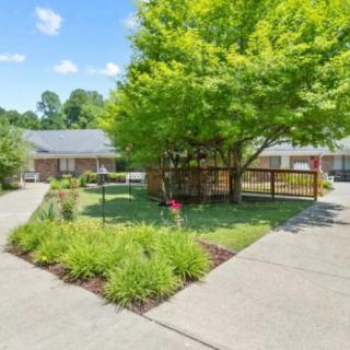 A well-maintained residential property with a landscaped garden and driveway.