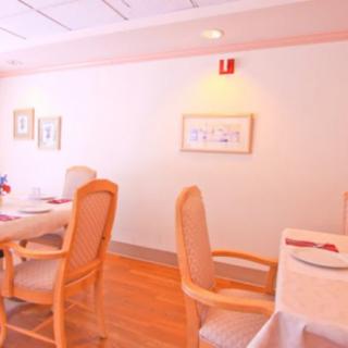 A cozy dining area with elegantly set tables and comfortable chairs.