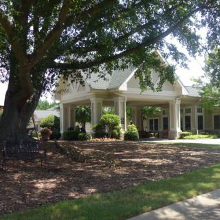 A well-maintained building surrounded by lush greenery and landscaping.