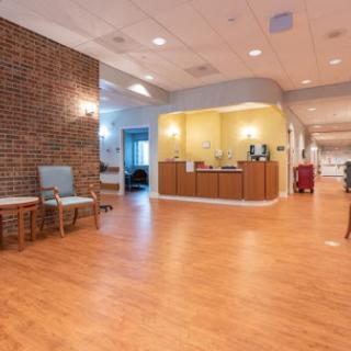 A spacious hospital reception area featuring a comfortable waiting space and modern furnishings.