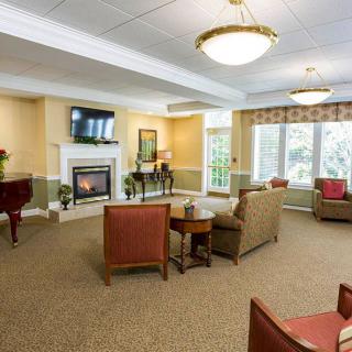 A cozy living room featuring comfortable seating, a fireplace, and a television.
