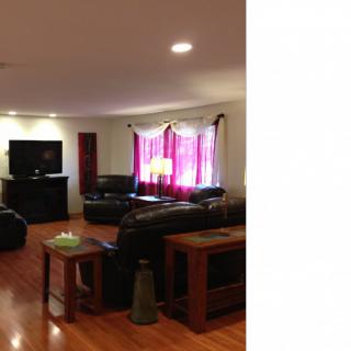 A cozy living room with leather sofas and a television.