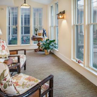 A cozy, bright living space with large windows and comfortable seating.