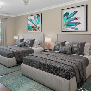 A modern bedroom with two neatly arranged beds, complemented by contemporary artwork and matching bedside lamps.