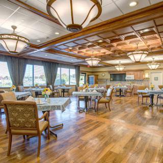 A beautifully designed dining room featuring elegant furniture and warm lighting.