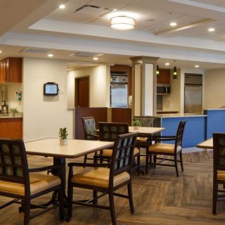 A modern dining area with neatly arranged tables and chairs.