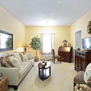 A cozy living room with classic furnishings and warm lighting.