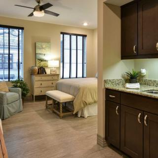 A cozy and modern bedroom with stylish furnishings and warm lighting.