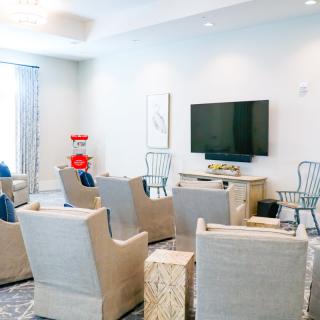 A modern living room with comfortable seating and a mounted television.