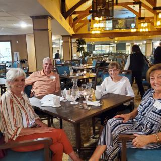 A group of people enjoying a meal together at a restaurant.
