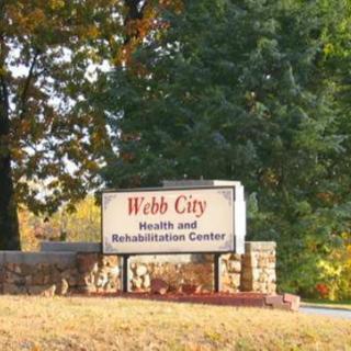 Sign for Webb City Health and Rehabilitation Center surrounded by trees.