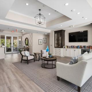 A modern and bright living room with elegant furniture and a television.
