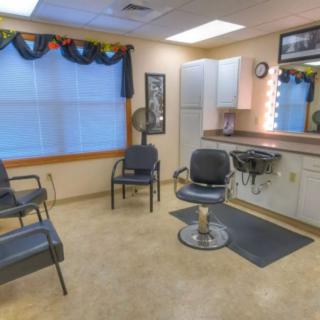 A cozy hair salon interior with a barber chair and waiting area.