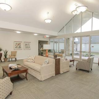 A modern living room with stylish furniture and large windows.