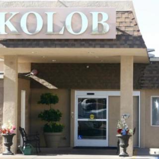 Entrance to a building with the sign 'KOLOB' displayed above the door.