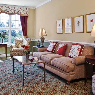 A cozy living room featuring a comfortable sofa, elegant coffee table, and decorative artwork on the wall.