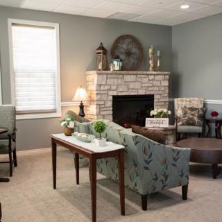 A cozy living room with modern decor and a fireplace.