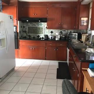 A well-equipped kitchen with wooden cabinets and modern appliances.