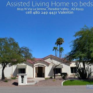 Image of an assisted living facility with palm trees in the background.