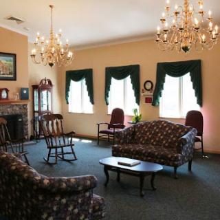 A cozy living room featuring elegant chandeliers and comfortable seating.