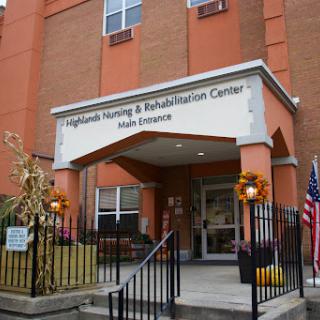 Entrance of the Highlands Nursing & Rehabilitation Center adorned with seasonal decorations.