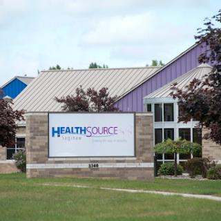 HealthSource medical facility showcasing its sign in a suburban area.