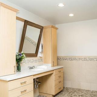 A modern bathroom featuring a sleek vanity with a sink, mirror, and natural elements.