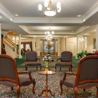 A classic interior lobby with elegant furniture and chandeliers.