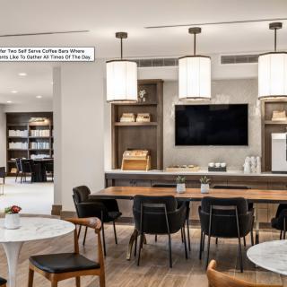 A modern dining area with elegant lighting and wooden furnishings.