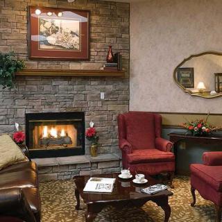 A cozy living room with a fireplace and traditional decor.
