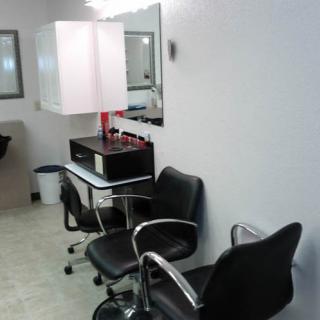 A clean and modern hair salon setup with chairs and mirrors.