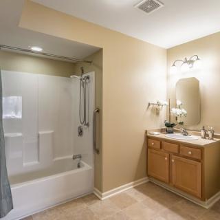 A modern bathroom with a shower-tub combo and a vanity sink.