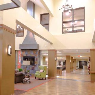 A spacious lobby with comfortable seating, modern decor, and ample natural lighting.