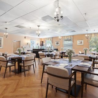 A well-lit dining area featuring modern furniture and a welcoming atmosphere.
