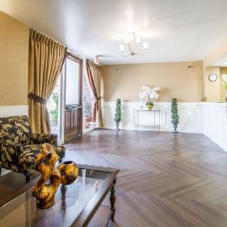 A warmly decorated lobby area with a seating arrangement and decorative accents.