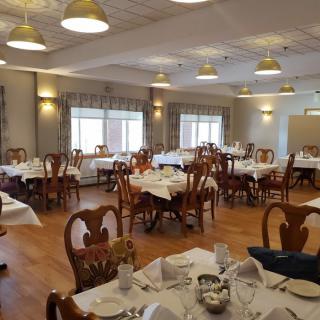 An elegant dining room with neatly arranged tables and chairs, ready for guests.
