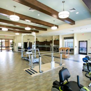 A modern and spacious fitness center equipped with various exercise machines.