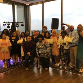 A joyful group celebrating their achievements at a recent awards ceremony.