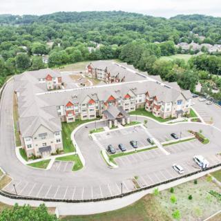 Aerial view of a suburban residential complex surrounded by greenery.
