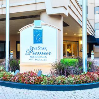Entrance to a hotel with prominent signage and well-maintained landscaping.